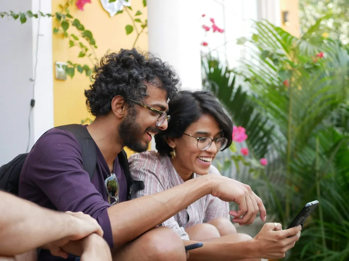 Two colleagues looking at a health app on a phone